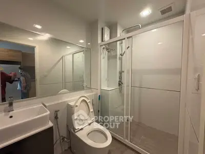 Modern bathroom with glass shower and sleek fixtures