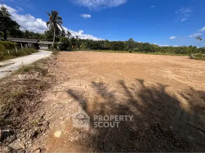 Expansive plot of land with clear blue sky, ideal for development or investment opportunities.