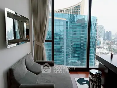Modern living room with stunning city view through floor-to-ceiling windows, featuring sleek furniture.