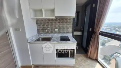 Modern compact kitchen with stunning city view and sleek design