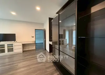 Spacious modern living room with sleek cabinetry and large TV unit.