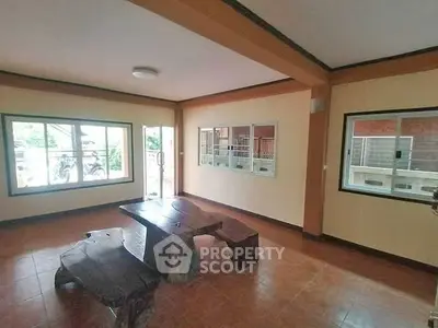 Spacious living room with rustic wooden furniture and large windows