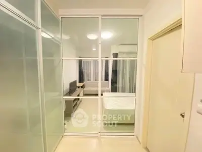 Modern bedroom with glass sliding doors and minimalist decor