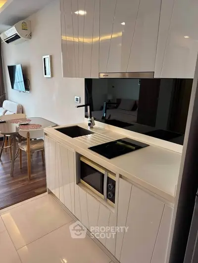 Modern kitchen with sleek cabinetry and built-in appliances in a stylish apartment.