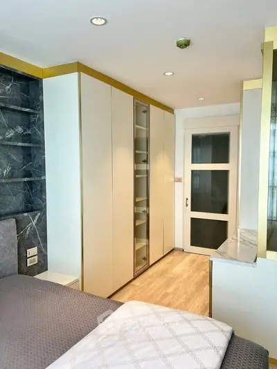 Modern bedroom with sleek built-in wardrobe and elegant decor