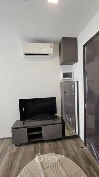 Modern living room with air conditioning and sleek TV setup