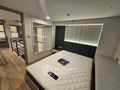 Modern bedroom with stylish design and ample natural light in a contemporary apartment.