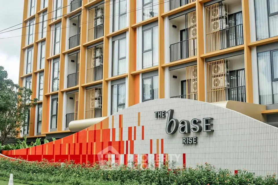 Modern apartment building exterior with vibrant design and lush landscaping.