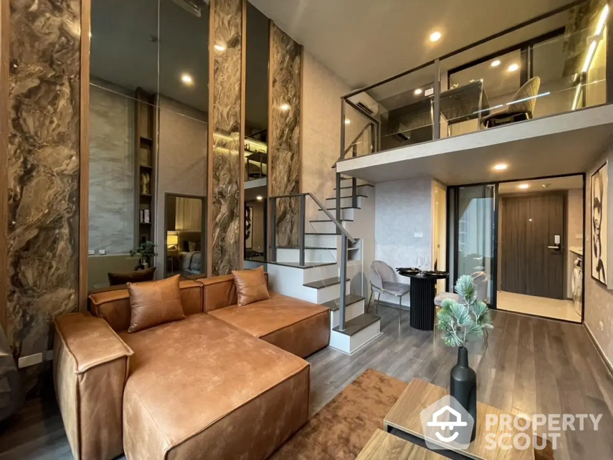 Luxurious modern loft apartment with mezzanine and stylish leather sofa in open living area.