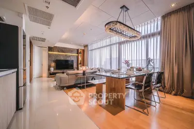 Luxurious open-plan living and dining area with modern decor and large windows.