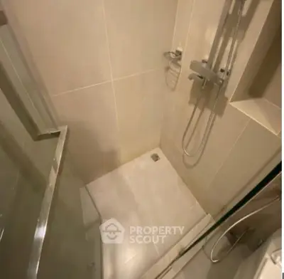 Modern bathroom with sleek shower design and glass door enclosure.