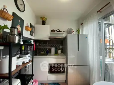 Charming compact kitchen with modern appliances and natural light