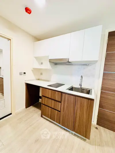 Modern kitchen with sleek cabinetry and integrated appliances in a stylish apartment.