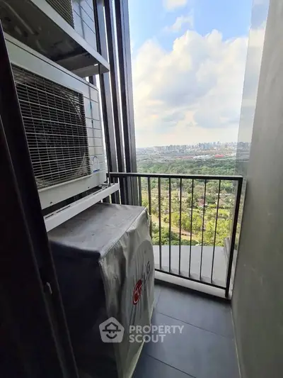 Stunning balcony view with cityscape and lush greenery, featuring modern air conditioning units.