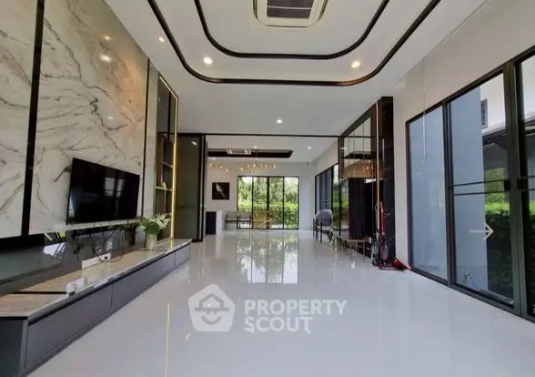 Luxurious modern living room with marble accents and large windows