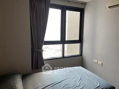 Cozy bedroom with large window and air conditioning unit