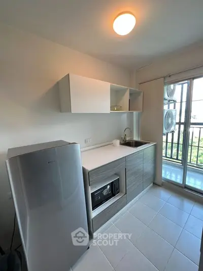 Modern kitchen with sleek appliances and balcony view