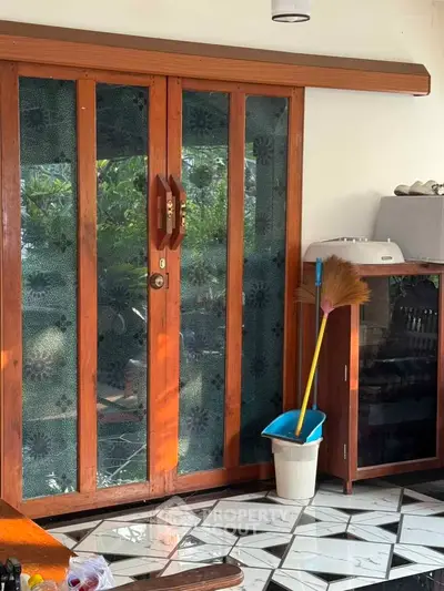 Charming wooden door with decorative glass panels in a cozy interior setting.