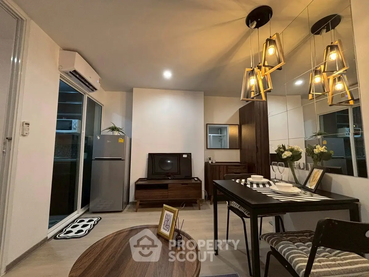 Modern living room with stylish decor and open layout, featuring elegant lighting and a cozy atmosphere.