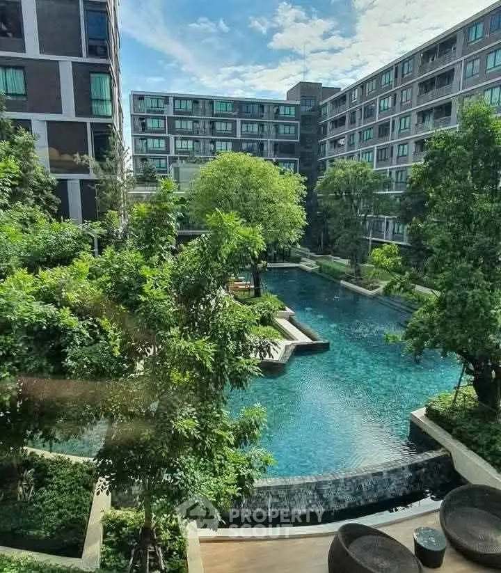 Luxurious apartment complex with stunning pool view and lush greenery