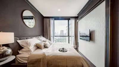 Luxurious bedroom with city view, elegant decor, and modern amenities.