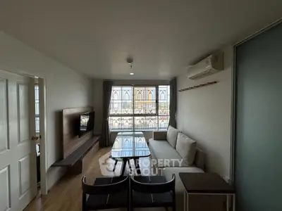 Modern living room with stylish furniture and large windows offering natural light.