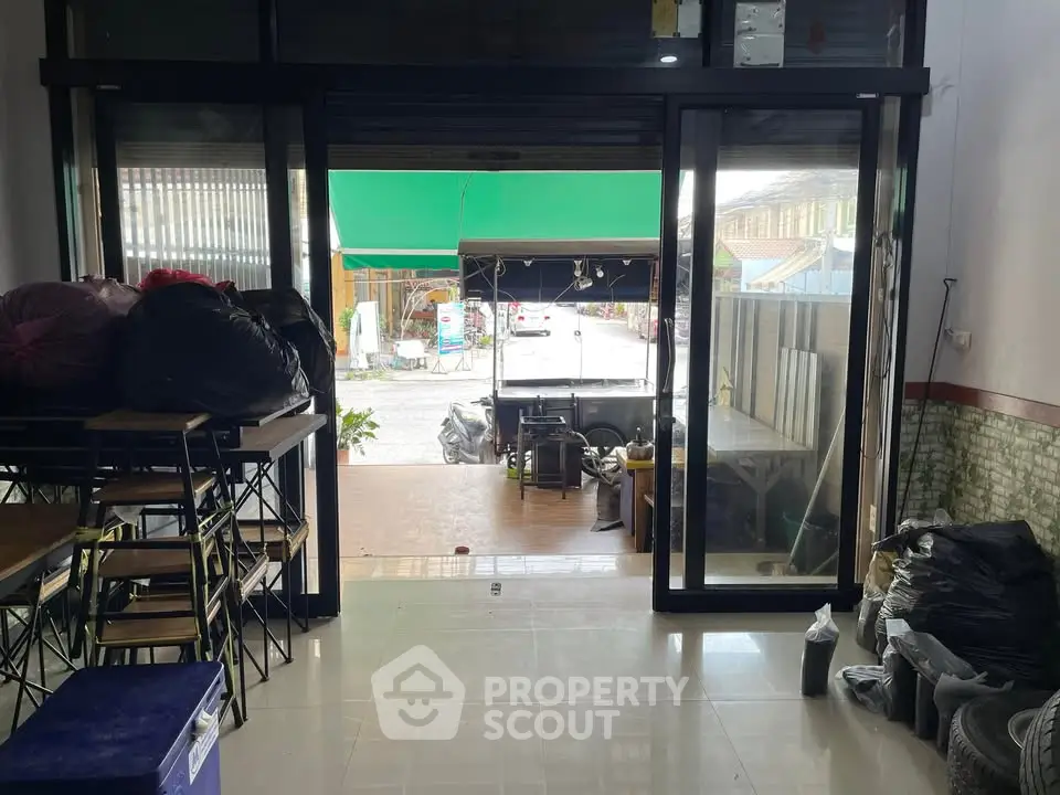 Spacious commercial space with large glass doors and tiled flooring