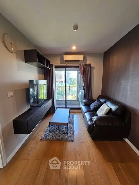 Modern living room with sleek furniture and city view balcony