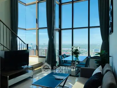 Stunning high-rise living room with floor-to-ceiling windows and panoramic city views.