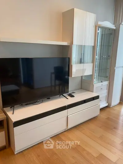 Modern living room with sleek TV stand and wooden flooring