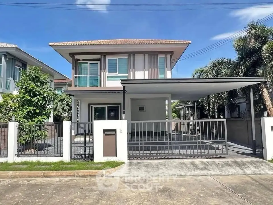 Modern two-story house with spacious driveway and lush greenery, perfect for family living.