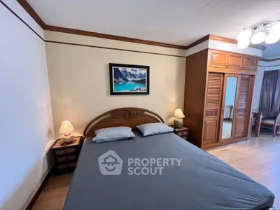 Spacious bedroom with elegant wooden furniture and cozy lighting