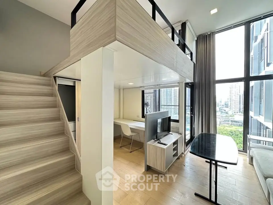 Modern loft apartment with mezzanine, large windows, and city view