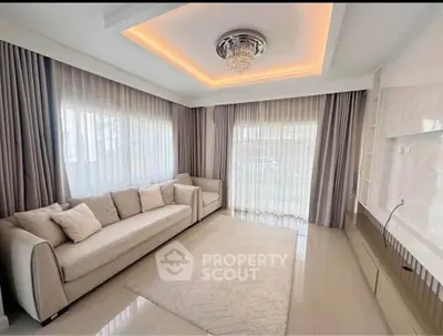 Elegant living room with modern chandelier and large windows