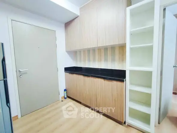 Modern kitchen with sleek wooden cabinets and open shelving
