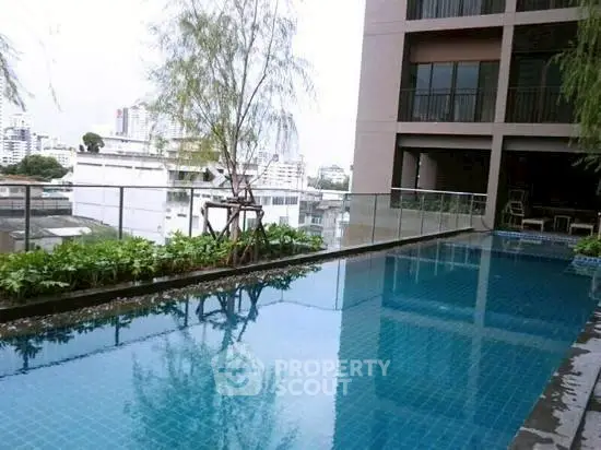 Luxurious rooftop pool with city view in modern apartment complex