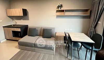 Modern living room with compact kitchen and dining area in stylish apartment
