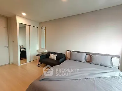 Modern bedroom with sleek design and mirrored closet doors