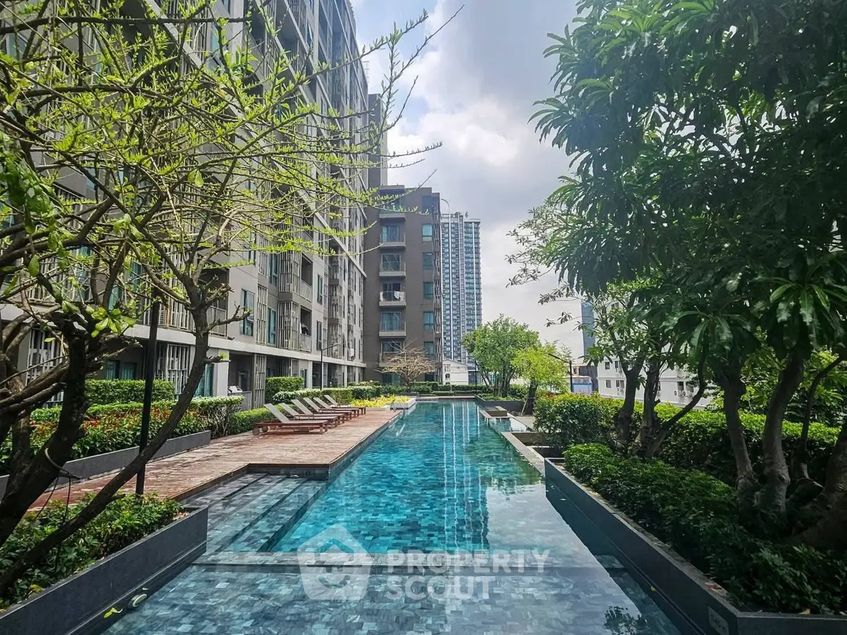 Luxurious residential building with stunning outdoor pool and lush greenery