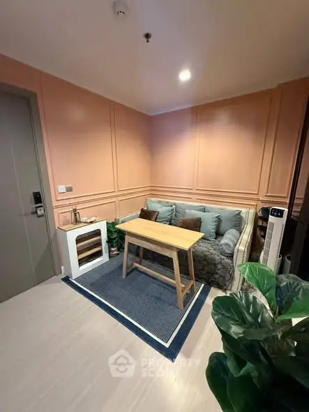 Cozy living room with modern decor and comfortable seating in a stylish apartment.