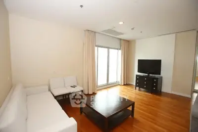 Spacious living room with modern furniture and large windows for natural light.