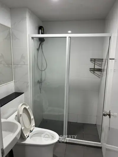 Modern bathroom with glass shower enclosure and sleek fixtures