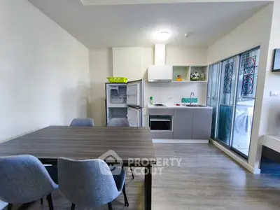 Modern kitchen with dining area and open fridge, sleek design