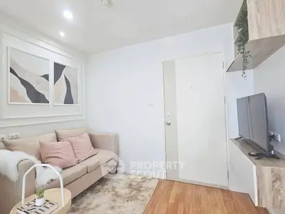 Cozy living room with modern decor, plush sofa, and wall-mounted TV in a stylish apartment.