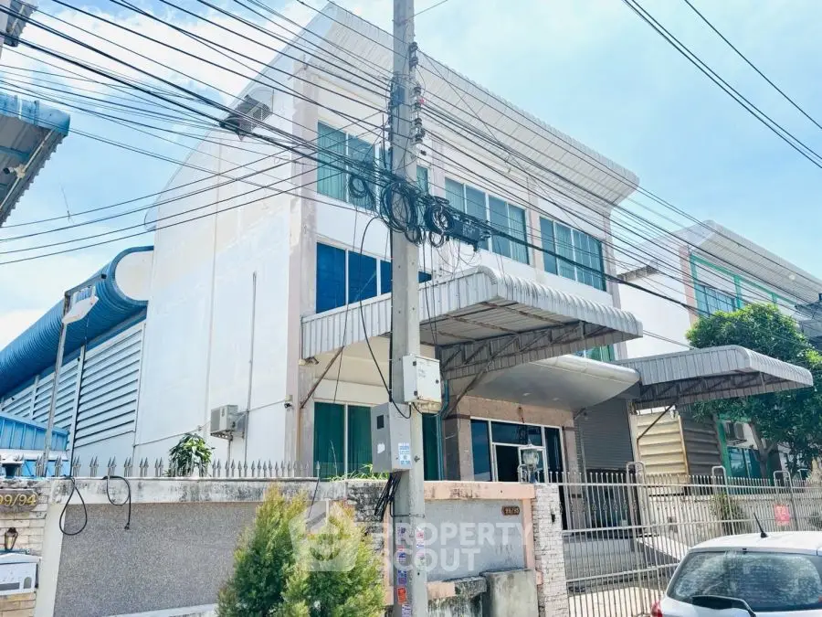 Modern industrial building with gated entrance and large windows