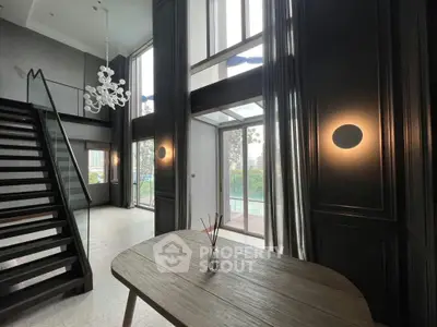 Stunning modern interior with high ceilings and elegant staircase, perfect for luxury living.