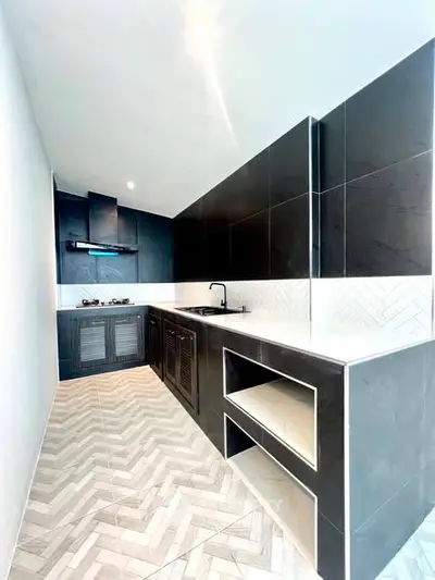 Sleek modern kitchen with black cabinetry and herringbone tile flooring
