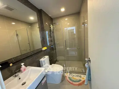 Modern bathroom with glass shower, sleek fixtures, and stylish design