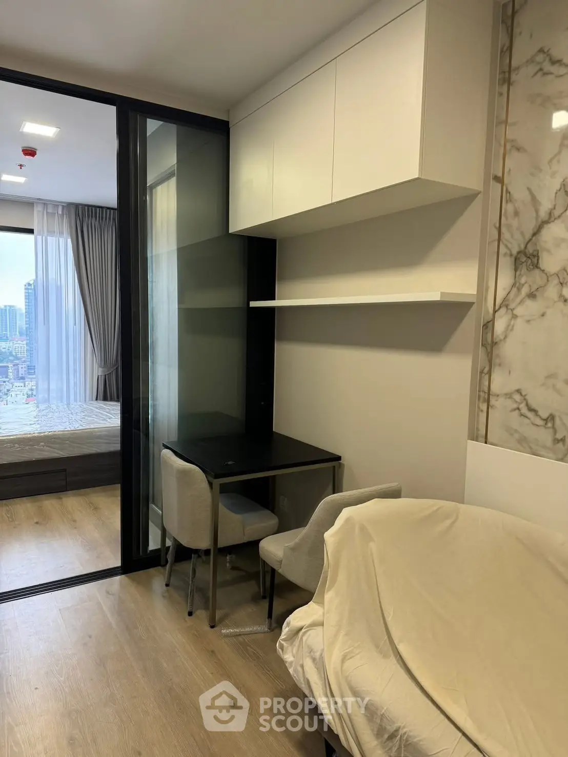 Modern apartment interior with stylish furniture and city view from the window.