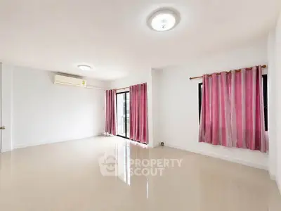 Spacious empty living room with pink curtains and air conditioning, perfect for customization.